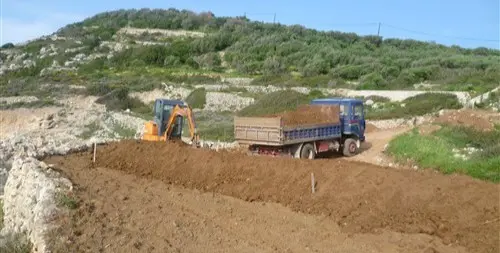 Truck delivering soil to a garden